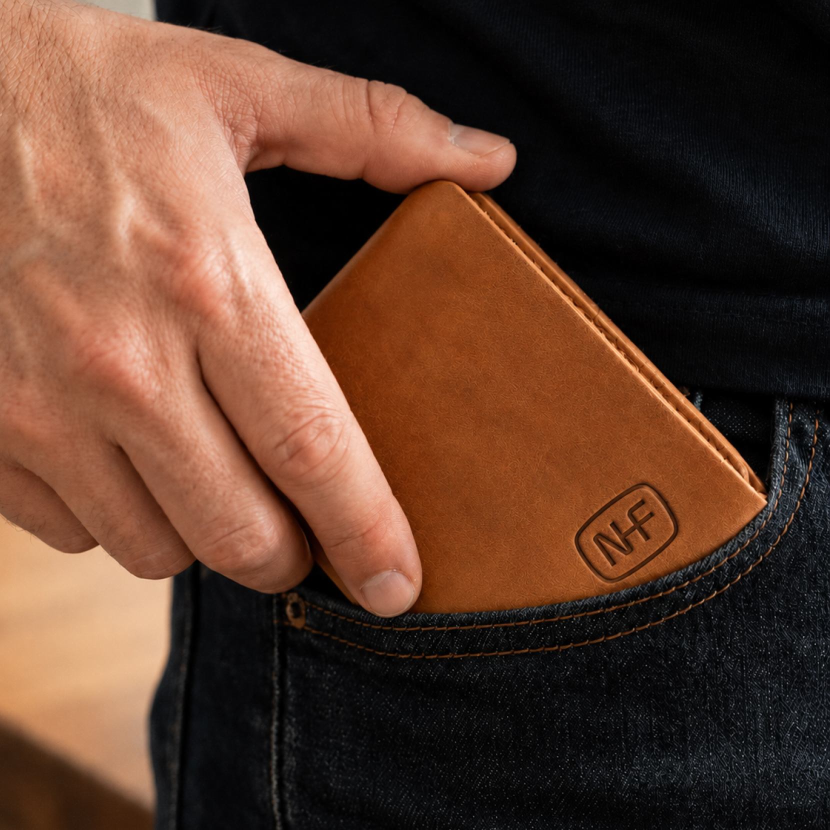 Leather wallet embossed with a Next Frontier Capital NF monogram